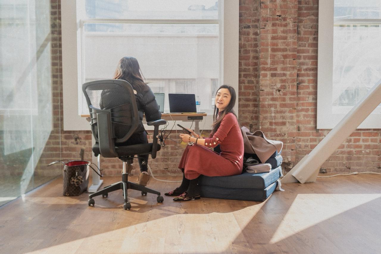 Two people hanging out in a bright loft space